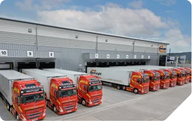 Industrial logistics warehouse with trucks at loading bays