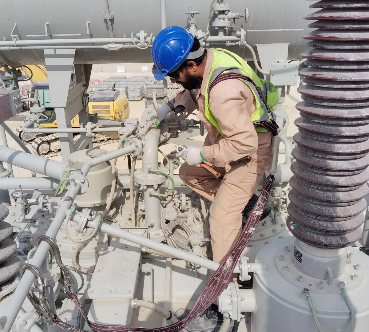 Technician working on substation electrical infrastructure